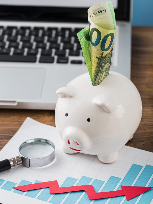 cropped high angle office items with piggy bank growth chart 2