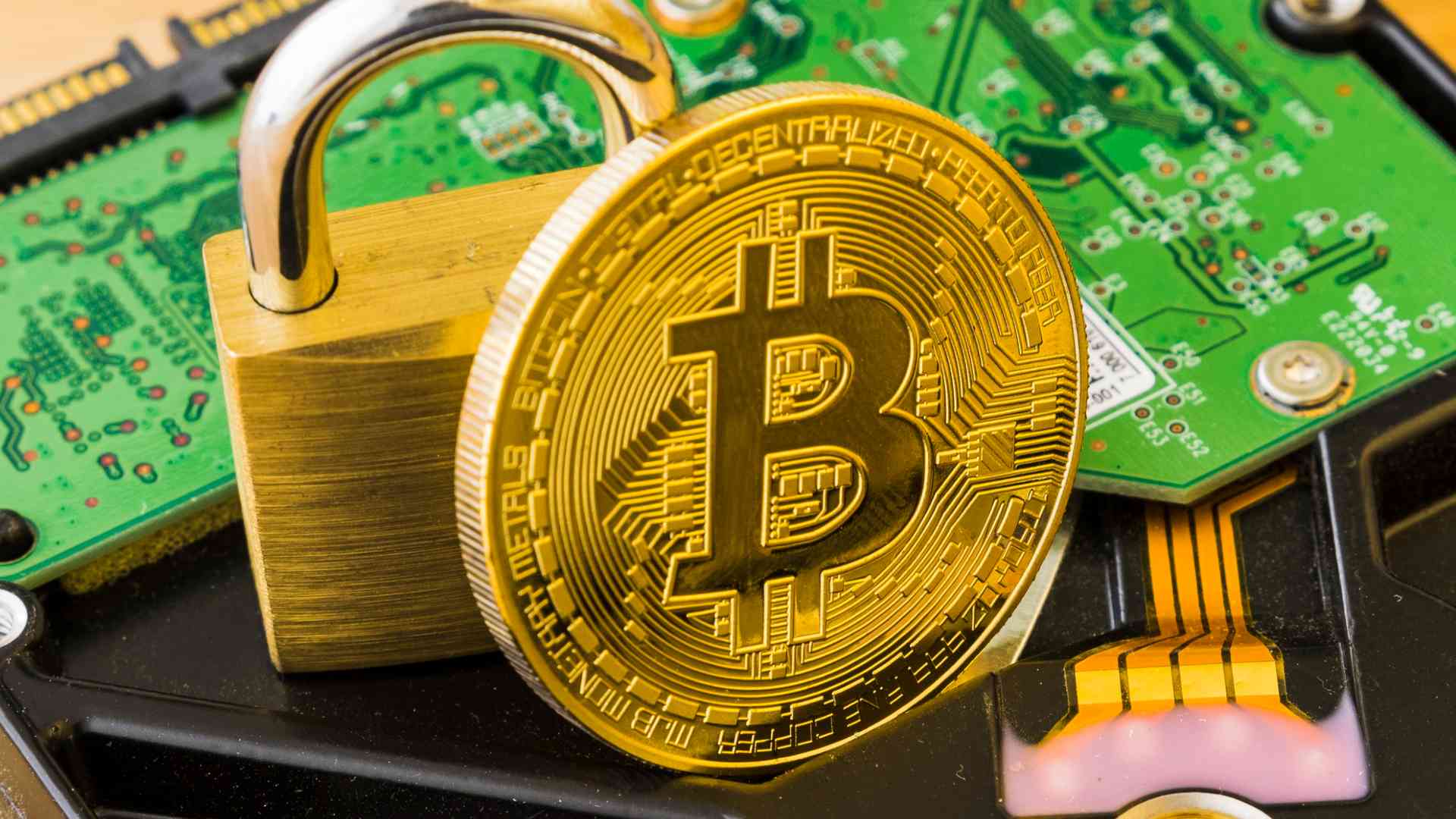 Bitcoin com cadeado proximo de placas de circuito eletronicos